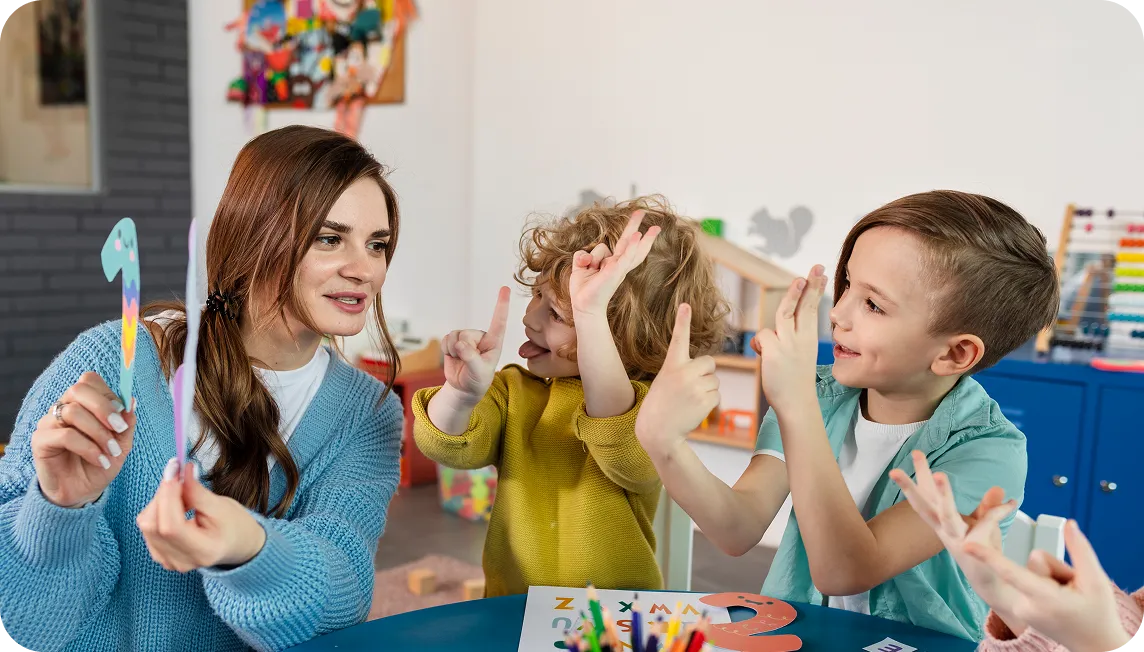 Kids and teacher at a table