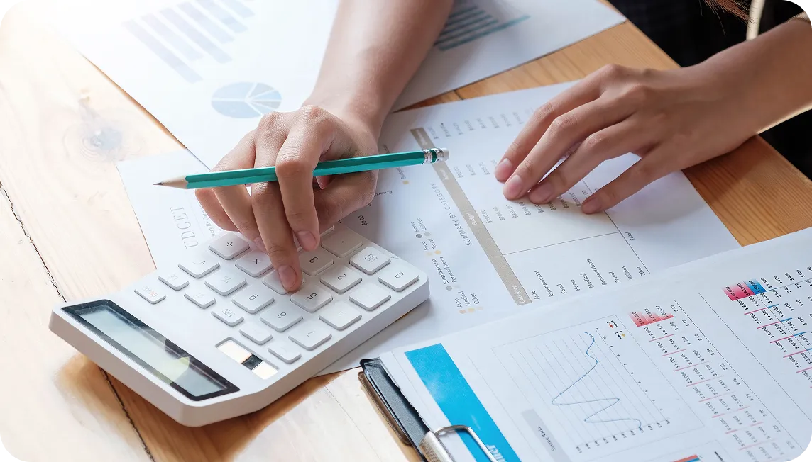 Businesswoman using calculator and laptop